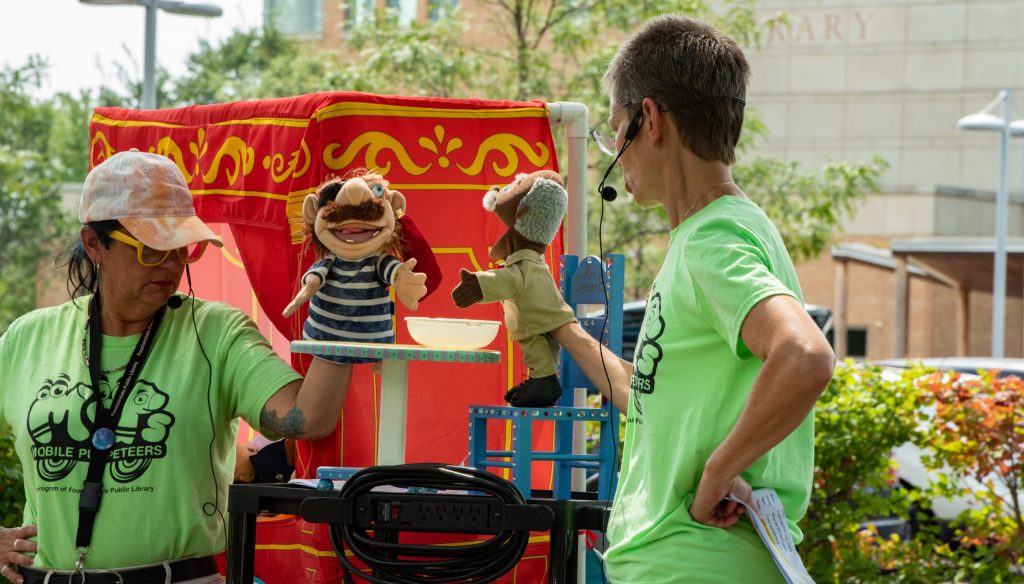 Two puppeteers putting on a puppet show