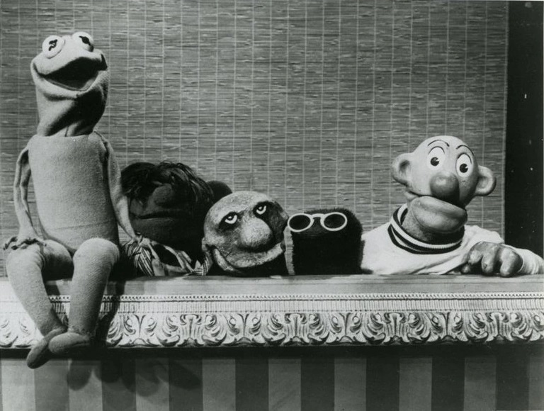 black and white still from the TV show Sam and Friends depicting an early Kermit puppet alongside other early Muppets