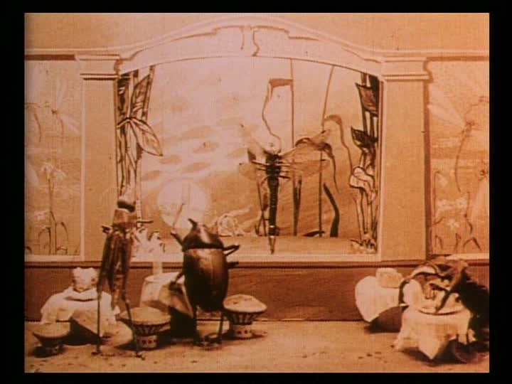 sepia-toned film still depicting a reanimated beetle and grasshopper looking at a painting on the wall