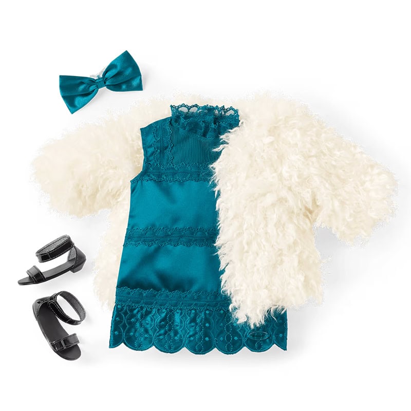 A teal dress with lace details, a white faux fur jacket, a teal bow hair accessory, and a pair of black heeled sandals are arranged on a white background.