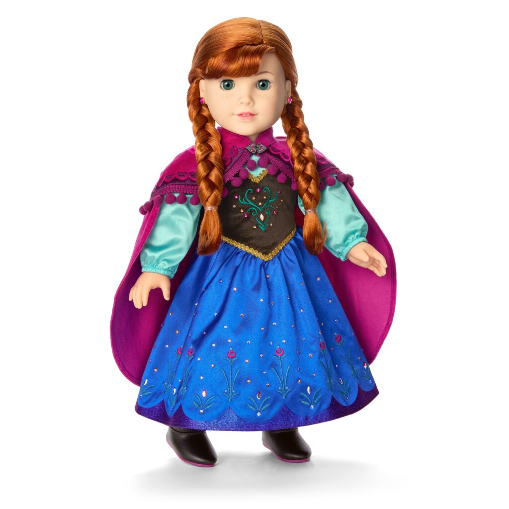 Doll with braided red hair wearing a blue dress, aqua blouse, black bodice, and a purple cape, standing upright.
