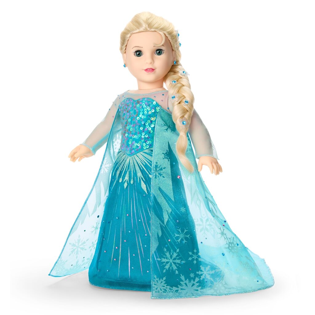 A blonde doll with blue eyes is dressed in a turquoise gown with snowflake patterns and a sheer cape, styled to resemble the character Elsa from Frozen.